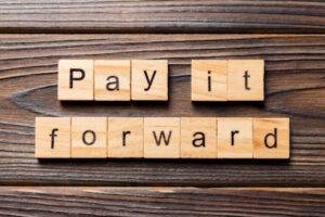 wooden blocks reading pay it forward